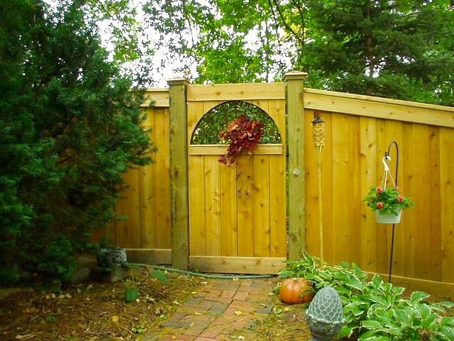 Ymca Lincoln Ne for a  Landscape with a Salvaged Grate and Custom Fence Project with Repurposed Floor Grate as Gate Window in Lincoln, Ne by Aesthetic Concrete Design