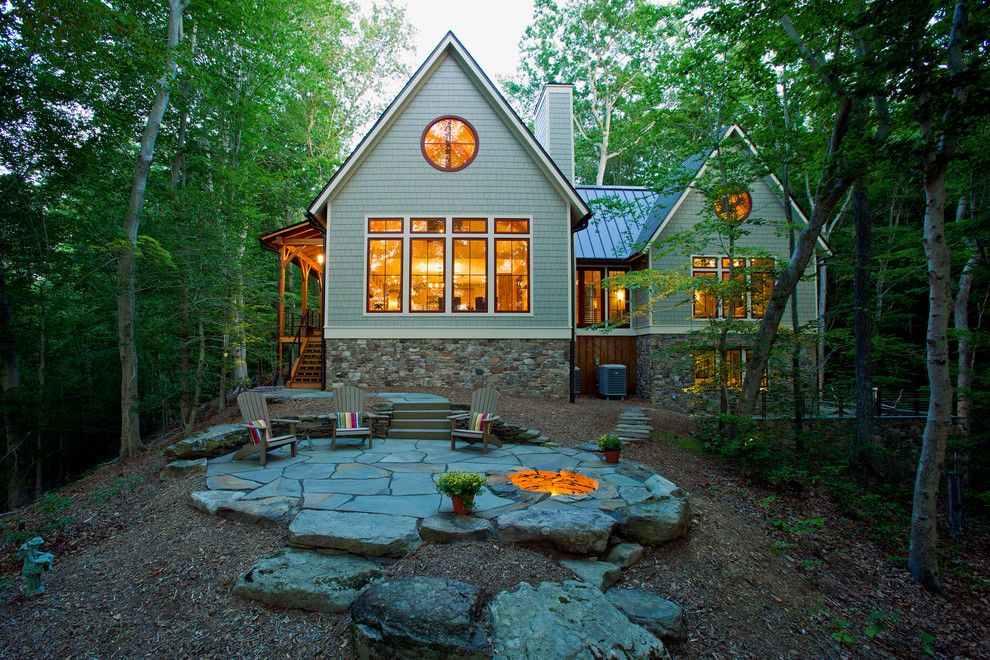 Adirondack Camp for a Rustic Exterior with a Natural Stone and Lakefront Timber Frame Home and Pavillions by Kohlmark Architects and Builders