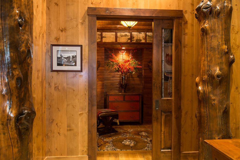 Adirondack Lodge for a Rustic Bathroom with a Sliding Pocket Door and Bathroom Suite by Gabberts Design Studio