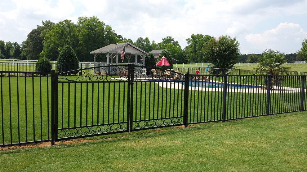 Allied Fence for a Traditional Exterior with a Black Wrought Iron Fence and Double Scroll Gate by Allied Fence Co