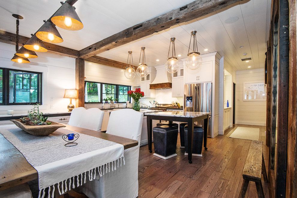 Aspen Contracting for a Rustic Dining Room with a Exposed Beams and Lake George Retreat by Phinney Design Group