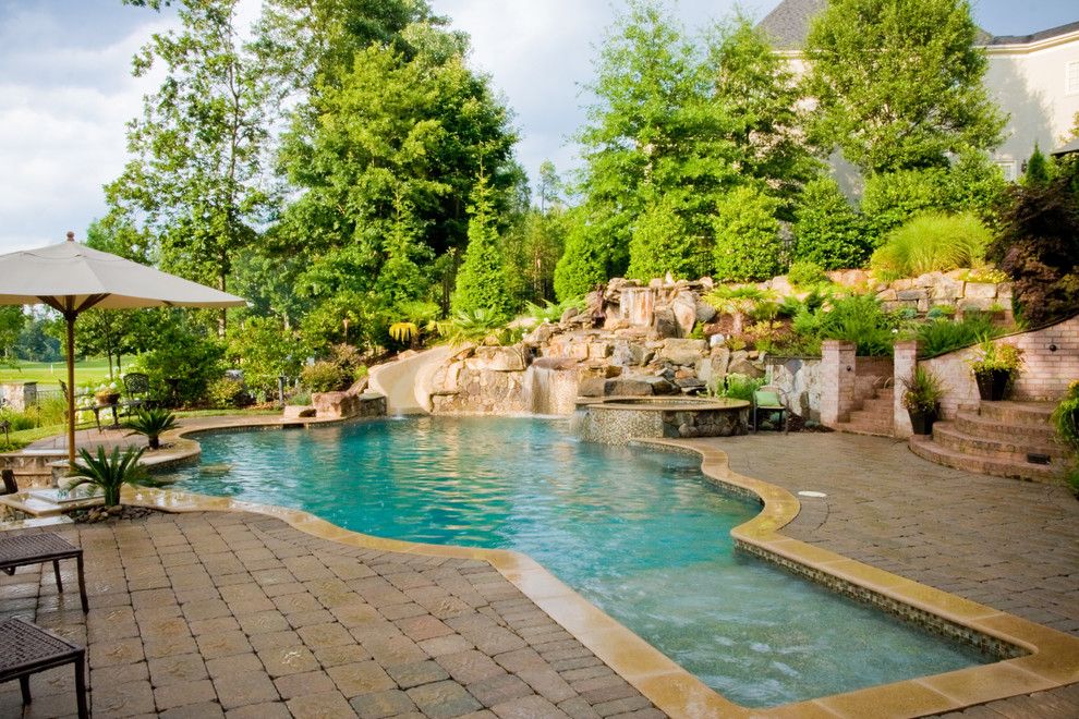 Ballantyne Spa for a Tropical Spaces with a Boulder Waterfall and Ballantyne Tropical Oasis by Coogan's Landscape Design