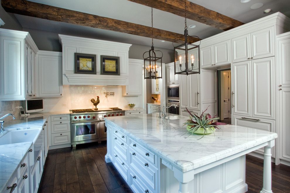 Bean Group Nh for a Traditional Kitchen with a Kitchen Tv and Raised Panel, White Cabinet Kitchen with Oversize Island, Hand Hewn Ceiling Beam by Orren Pickell Building Group