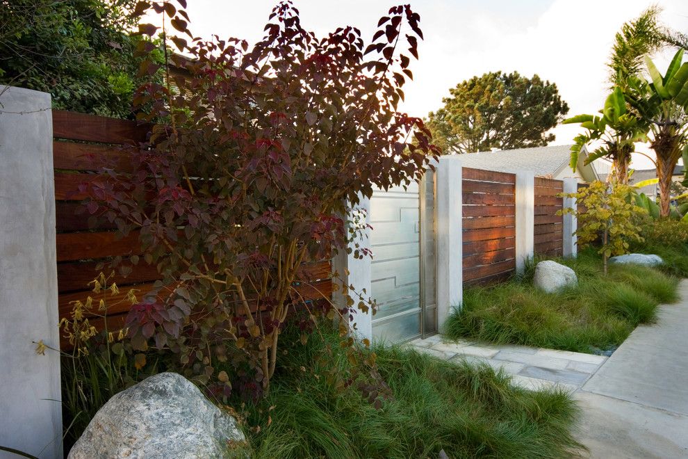 Boulder Lumber for a Modern Landscape with a Tall Grass and Serene Backyard by Hamilton Gray Design, Inc.