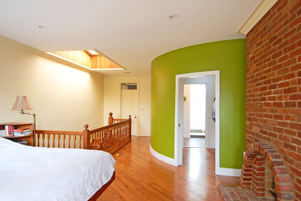 Brick Wall Waterfall for a Eclectic Bedroom with a Curved Wall and Capitol Hill Master Suite by Impact Remodeling and Construction