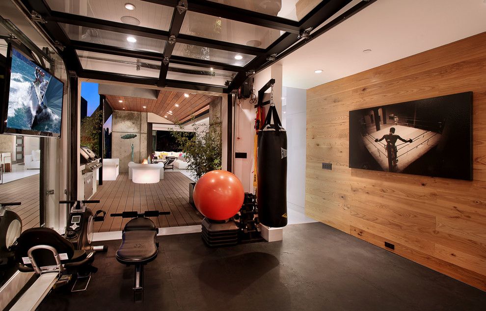 Broken Arrow Theater for a Contemporary Home Gym with a Wood Wall and Acacia by Brandon Architects, Inc.