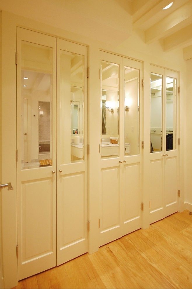 Brosco Doors for a Eclectic Closet with a Wood Floor and Boston Condo by Leslie Saul & Associates