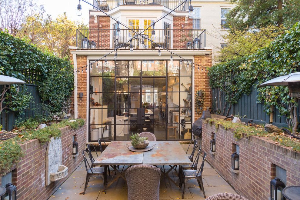 Brownstone Gardens for a Traditional Patio with a Brick Fireplace and Georgetown Kitchen / Patio by Overmyer Architects