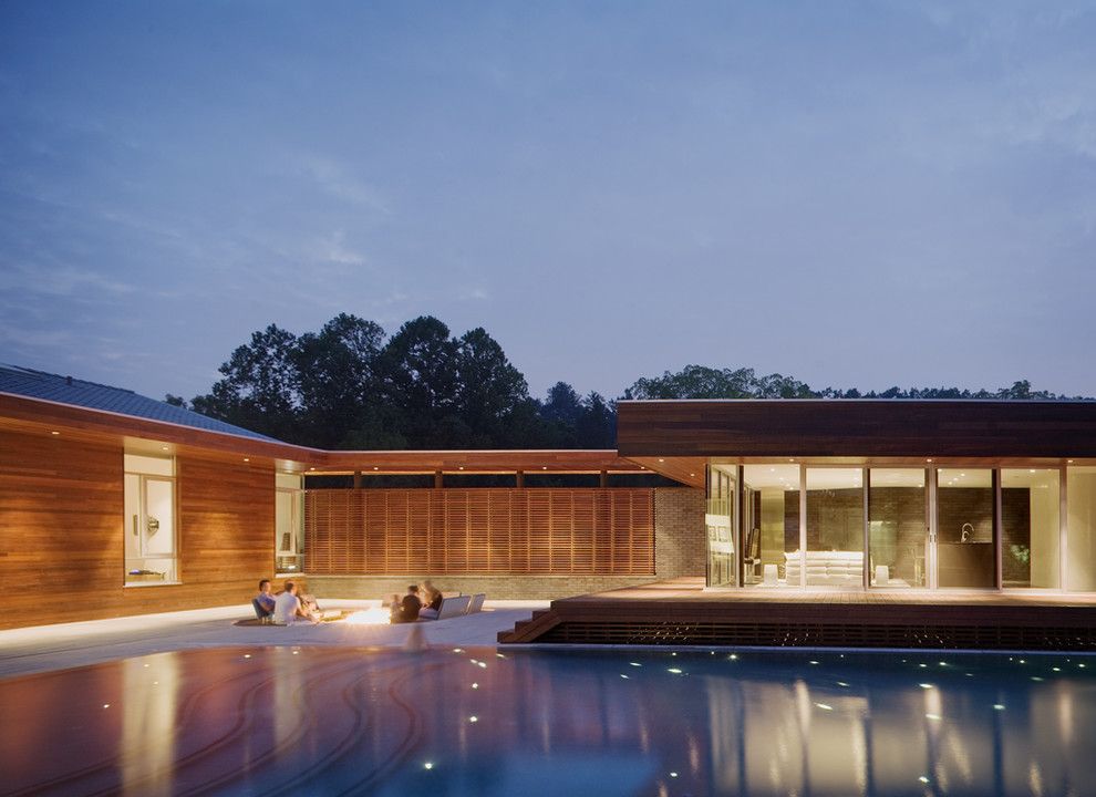 Budger for a Contemporary Pool with a Horizontal Slat Fence and Curved House by Hufft Projects