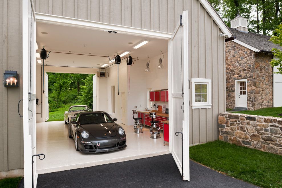 Chi Overhead Doors for a Farmhouse Garage with a Drive Thru Garage and Horseshoe by Griffiths Construction, Inc.