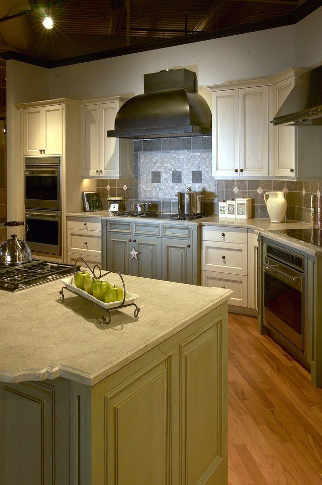 Clarks Appliances for a Traditional Kitchen with a Wolf Ventilation and Seagrass Limestone Counters and Stone Backspash by Clarke Appliance Showrooms