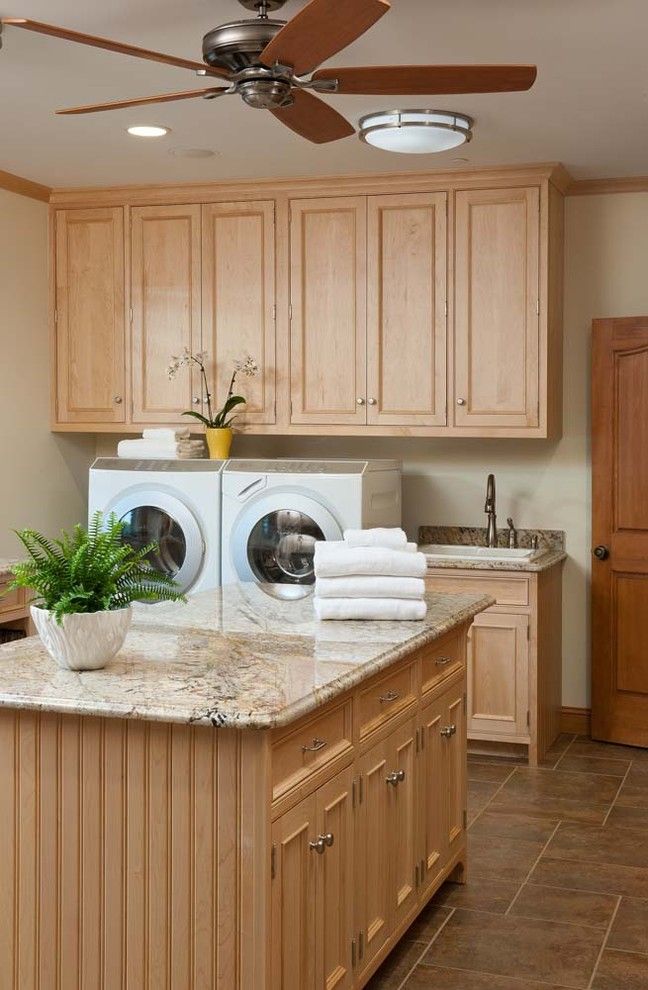 Cleaning Front Load Washer for a Traditional Laundry Room with a Ceiling Fan and Laundry/mud Room for a Busy Family by Crown Point Cabinetry