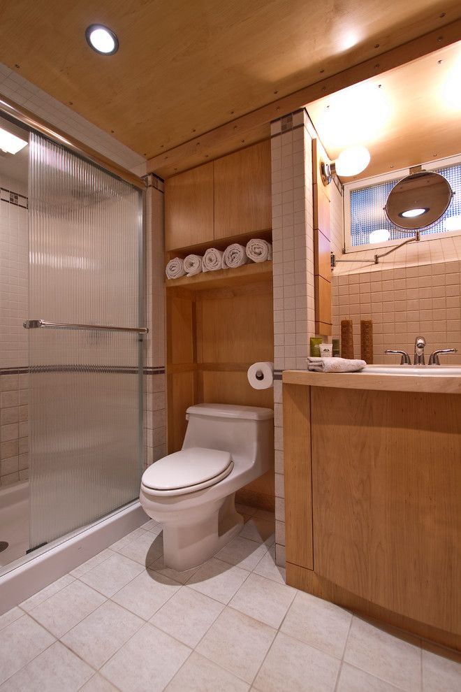 Commode Definition for a Contemporary Bathroom with a Glass Shower Door and Bath at Lower Level by Princeton Design Collaborative