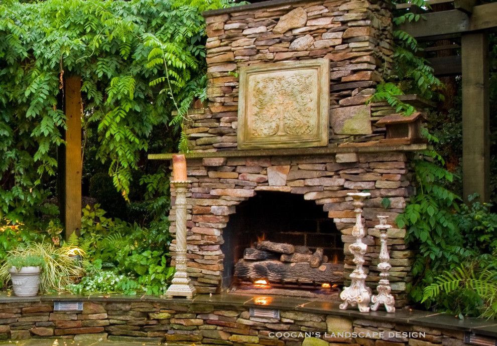 Coogans for a Midcentury Patio with a Curved Fireplace and Outdoor Fireplaces by Coogan's Landscape Design