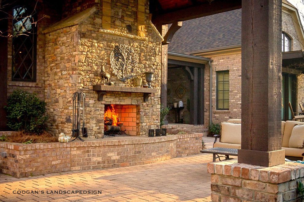 Coogans for a Midcentury Porch with a Paver Patio and Outdoor Fireplaces by Coogan's Landscape Design