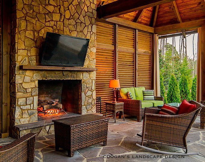 Coogans for a Midcentury Porch with a Paver Patio and Outdoor Fireplaces by Coogan's Landscape Design