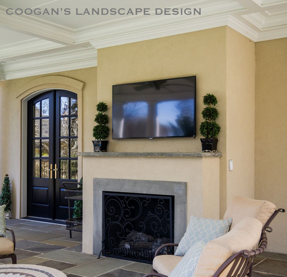 Coogans for a  Spaces with a Covered Porch and Outdoor Fireplaces by Coogan's Landscape Design