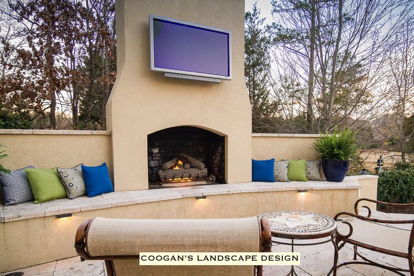 Coogans for a  Spaces with a Fireplace Seating Wall and Backyard Paradise by Coogan's Landscape Design