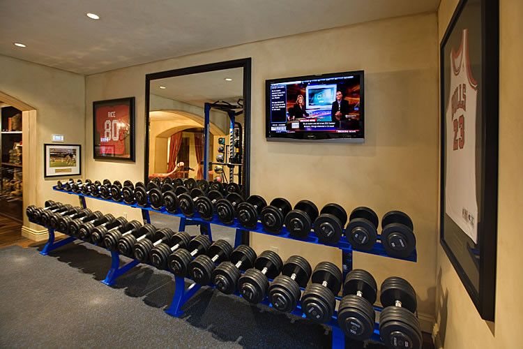 Costco Tv Mount for a Traditional Home Gym with a Large Wall Mounted Tv and Tv in Home Gym by Engineered Custom Systems, Inc.