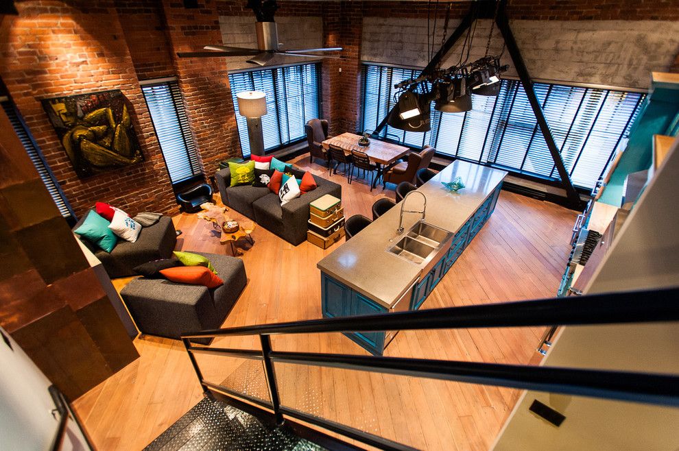 Custom Craftworks for a Industrial Family Room with a Wood Floor and Hamilton   Eclectic Industrial by Beyond Beige Interior Design Inc.