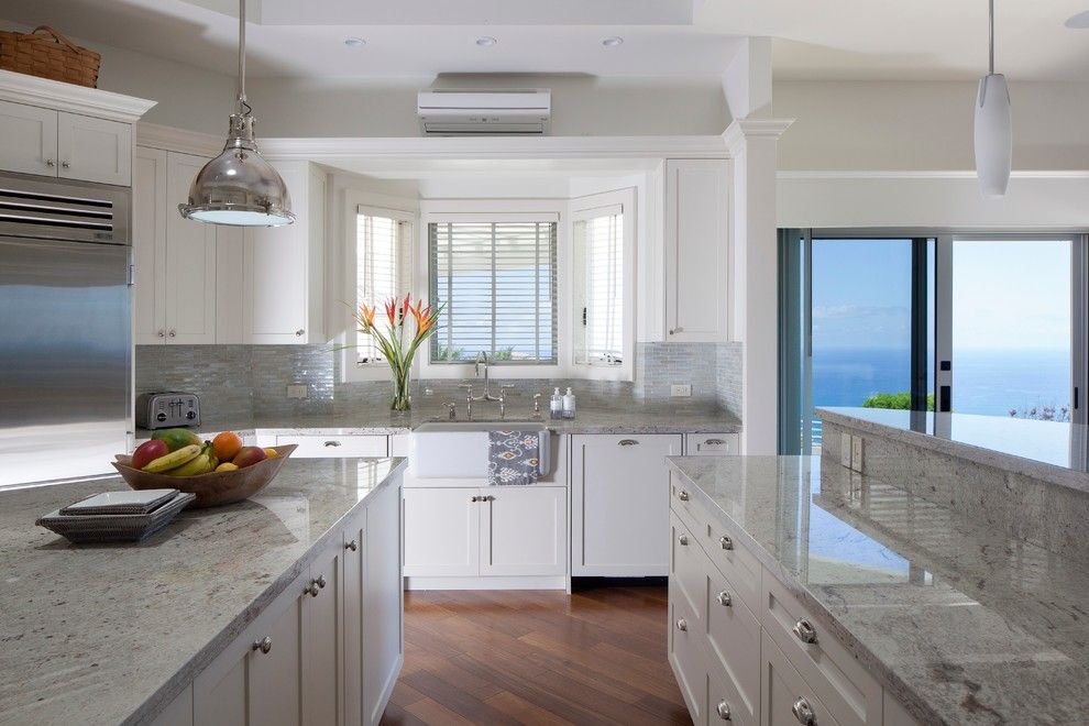 Cutting Edge Granite for a Tropical Kitchen with a Small Tile Backsplash and a Pristine Paradise by Barker Kappelle Construction, Llc