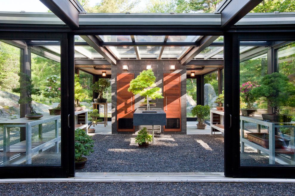 Dads Garage for a Modern Shed with a Glazed Brick Fireplace and Glass House in the Garden by Flavin Architects