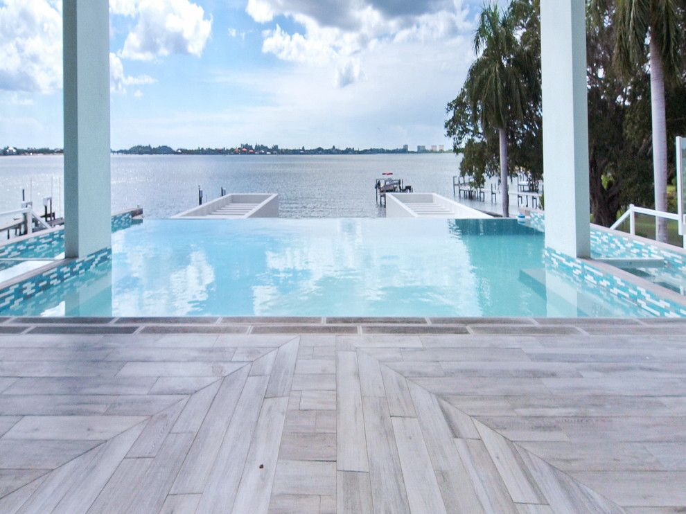 Decks and Docks for a Modern Pool with a White Pillars and Hillview Remodel by Yoder Homes