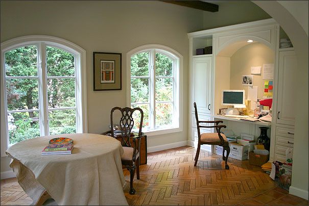 Eyebrow Arch for a Mediterranean Home Office with a Open Shelf Desk and Tuscan Treasure by Bowers Design Build