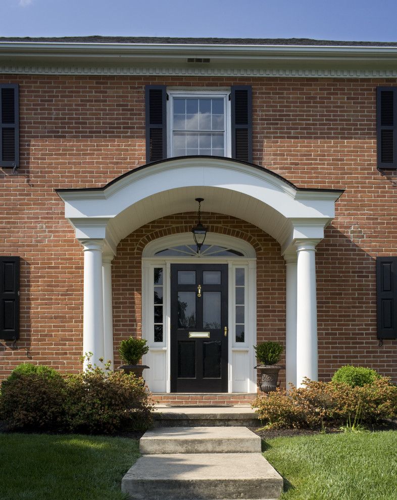 Frontroom Furnishings for a Traditional Entry with a Columns and Exterior Arch Portico Front Entry by Cushing Custom Homes, Inc.