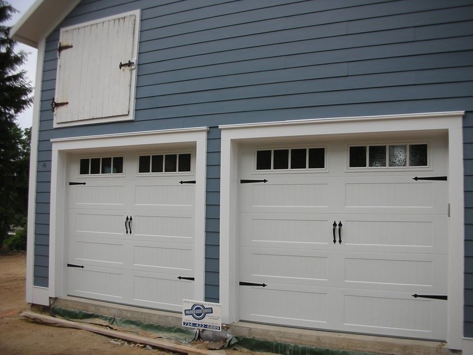 Garage Northville for a Farmhouse Garage with a Wood Garage Door and Carriage House Garage Doors by Premier Door Service