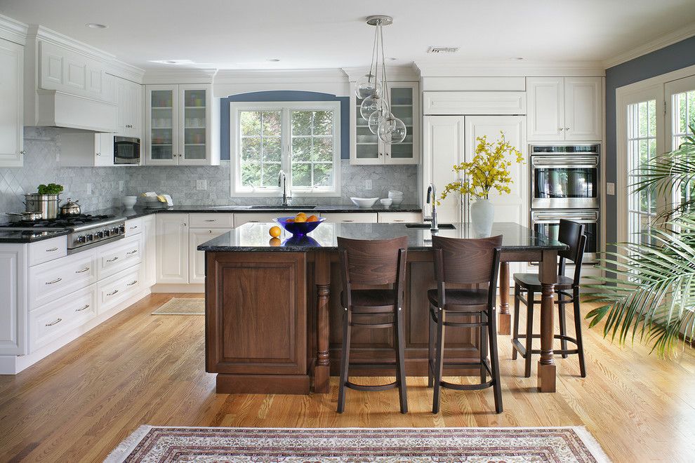 Gas Dryer vs Electric for a Transitional Kitchen with a Dark Wood Island and White Transitional Kitchen by Thyme & Place Design Llc