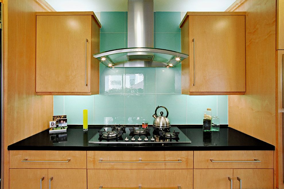 Glassed for a Contemporary Kitchen with a Black Engineered Stone Countertop and Large Glass Tile Backsplash by the Kitchen Collection