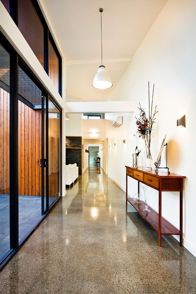 H&c Concrete Stain for a Contemporary Hall with a Glossy Floor and Red Hill Residence by Architecture Matters Pty. Ltd.