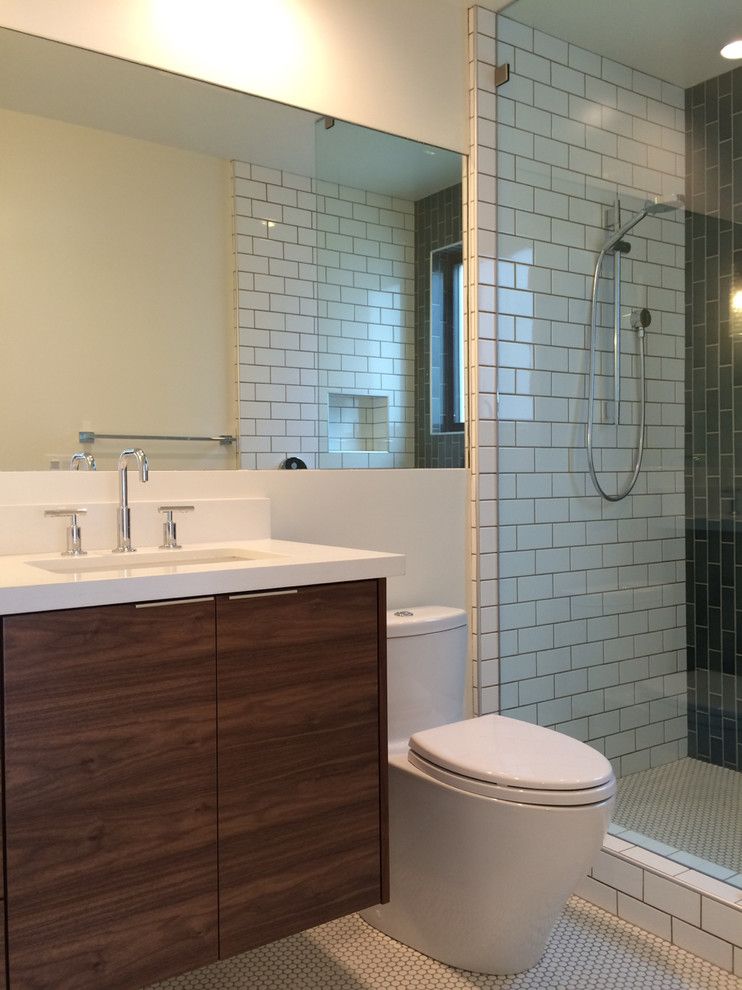 Heath Ceramics for a Midcentury Bathroom with a La Jolla and Bath with Walnut Vanity, Recessed Mirror, Subway Tile, and Heath Ceramics Blue T by Nau Builders, Inc.