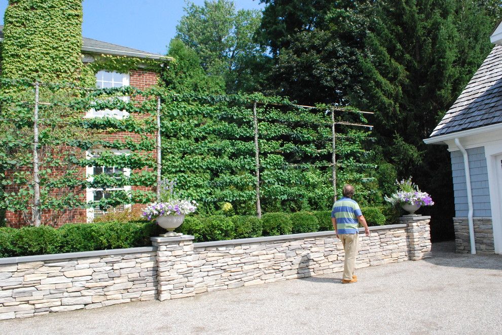 Hop Trellis for a Traditional Landscape with a Stone Planter Box and Lakefront Landscape by Deborah Silver and Co Inc