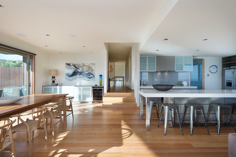 How to Clean Pergo Floors for a Modern Dining Room with a Frosted Glass Cabinet and Mark Gleeson Design by Matthew Mallett Photography