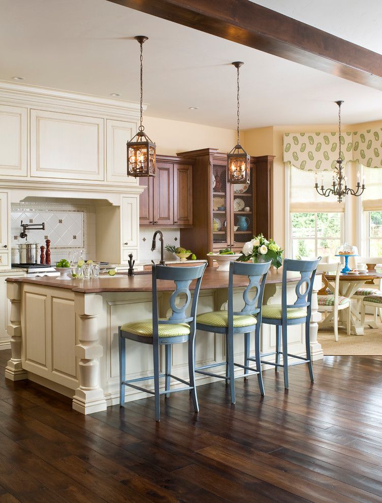 How to Lay Laminate Floor for a Transitional Kitchen with a White Tile Backsplash and Transitional Tudor by Design Transformations