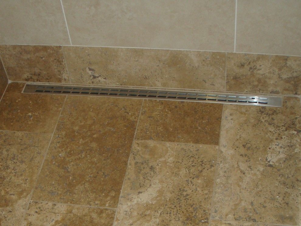 How to Unclog Shower Drain for a Tropical Bathroom with a Drawers and Linear Drain in Walk in Shower by by Design Builders