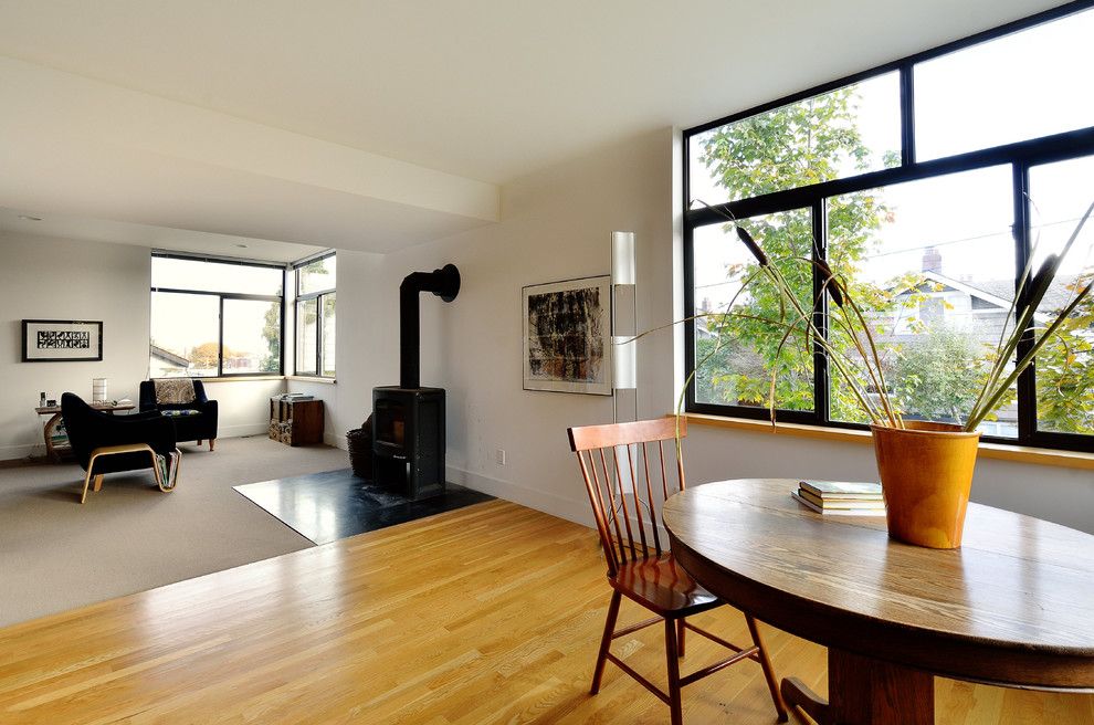 Installing a Wood Stove for a Modern Living Room with a Wood Floors and the Thicket by Studio Ectypos