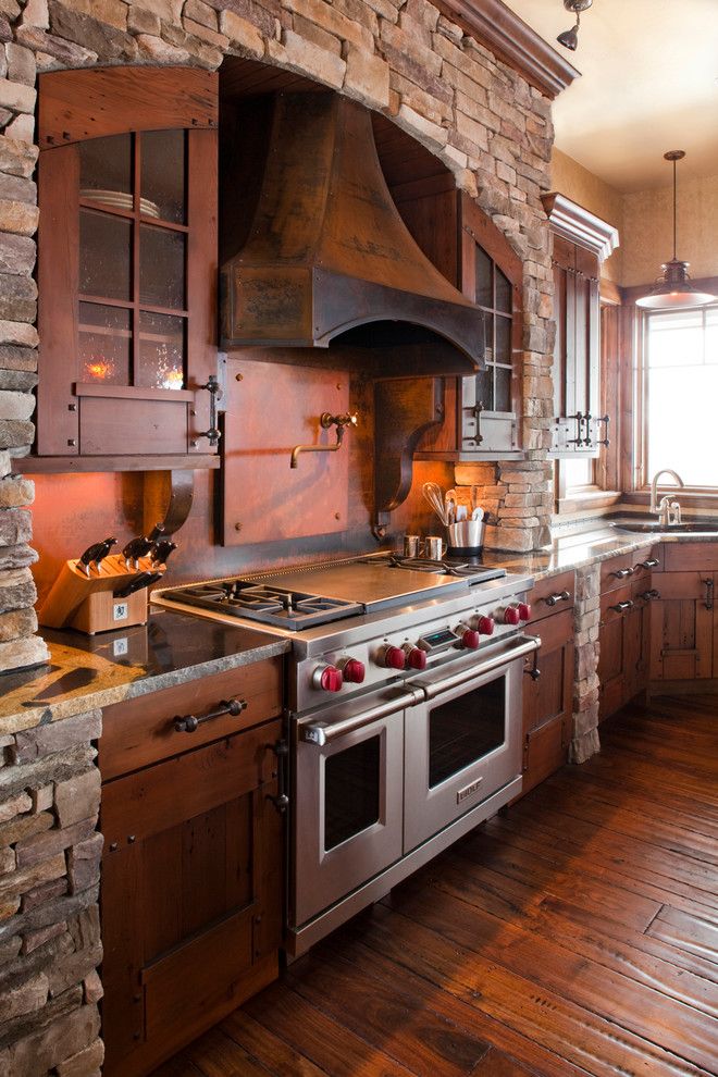 Installing a Wood Stove for a Rustic Kitchen with a Metal Range Hood and Rendezvous by Terra Firma Custom Homes