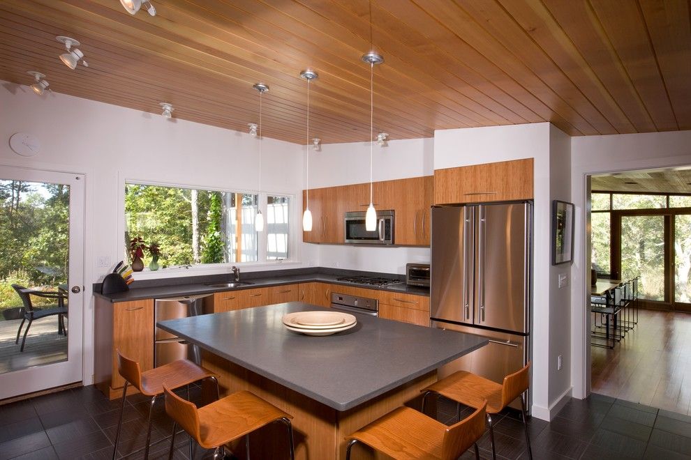 Intermountain Wood Products for a Midcentury Kitchen with a Dark Tile Floor and Mid Century Modern Addition, Truro by Hammer Architects