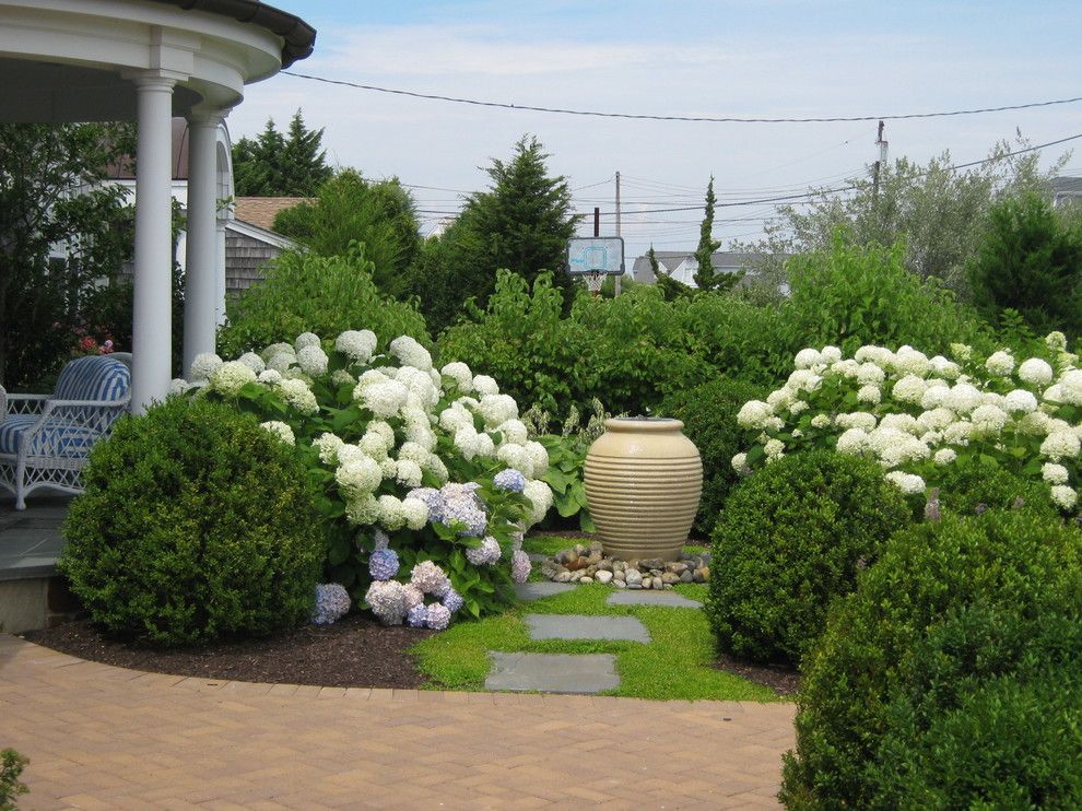 Kettle River Furniture for a Beach Style Landscape with a White Flowers and Shore Residence by Cross River Design, Inc.