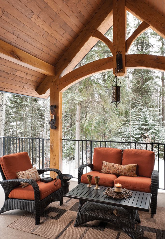 Levin Furniture Locations for a Rustic Deck with a Riverbend and Mountain Timber Frame Home in Canada by Riverbend Timber Framing