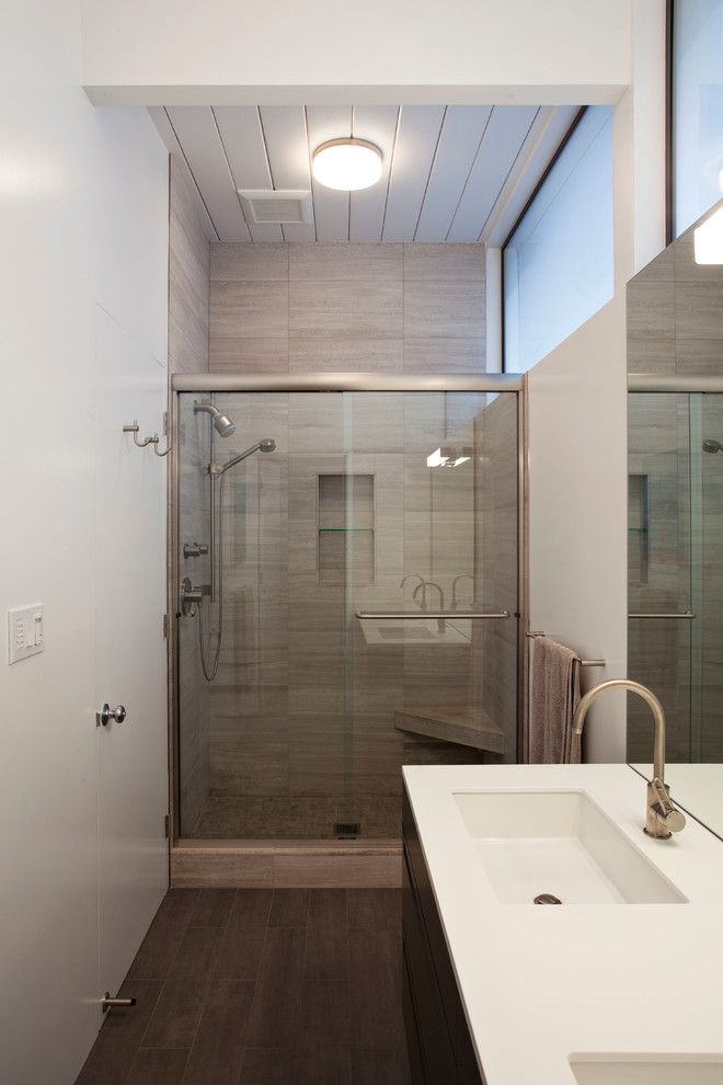 Luxe Hotel Sunset for a Midcentury Bathroom with a Dark Floor and Eichler Front Addition by Klopf Architecture