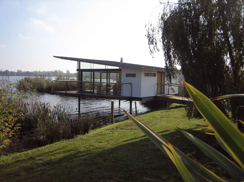 Mcloone's Pier House for a Midcentury Exterior with a Glass Doors and the Boat House by Ar Design Studio Ltd