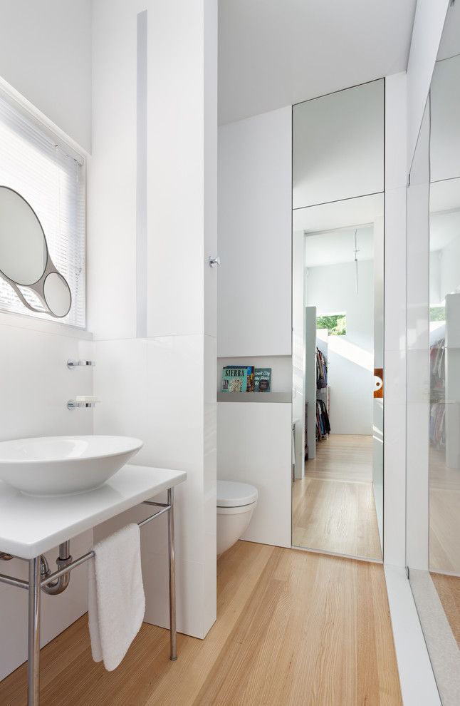 Michaels Flooring for a Contemporary Bathroom with a Round Mirror and Trees on the Roof by Meditch Murphey Architects