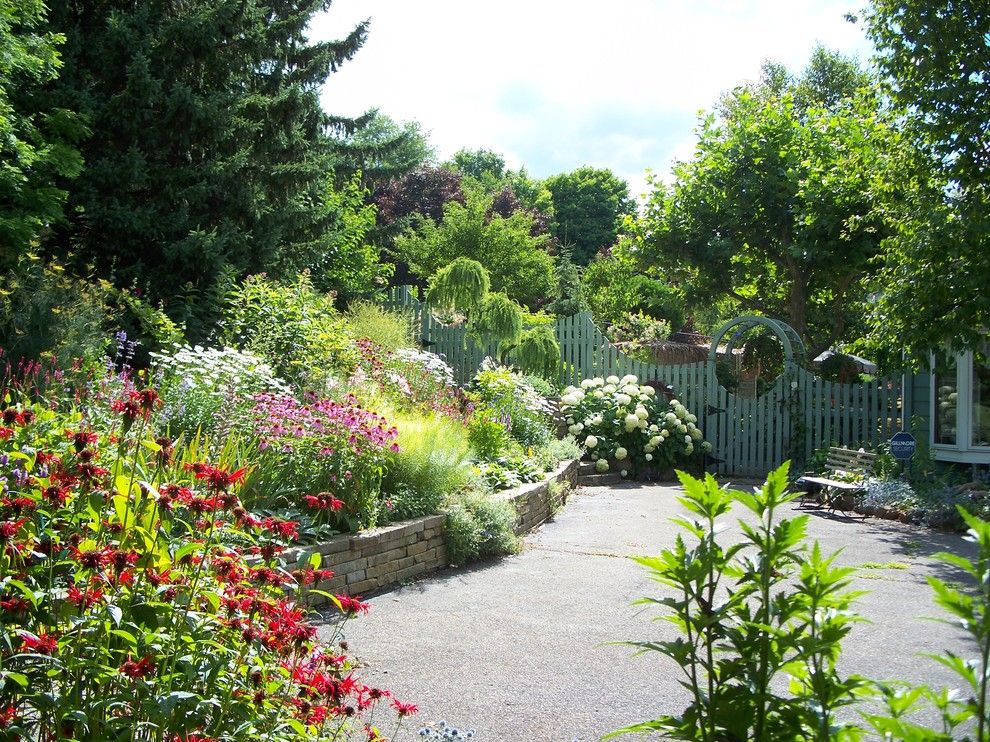 Midtown Arbor Place for a Traditional Landscape with a Green Fence and Change Throught the Years by Healy Design Inc.