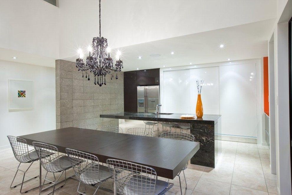 Monolithic Slab for a Industrial Kitchen with a White Cabinets and Orange, Black and White Kitchen by Du Bois Design Ltd