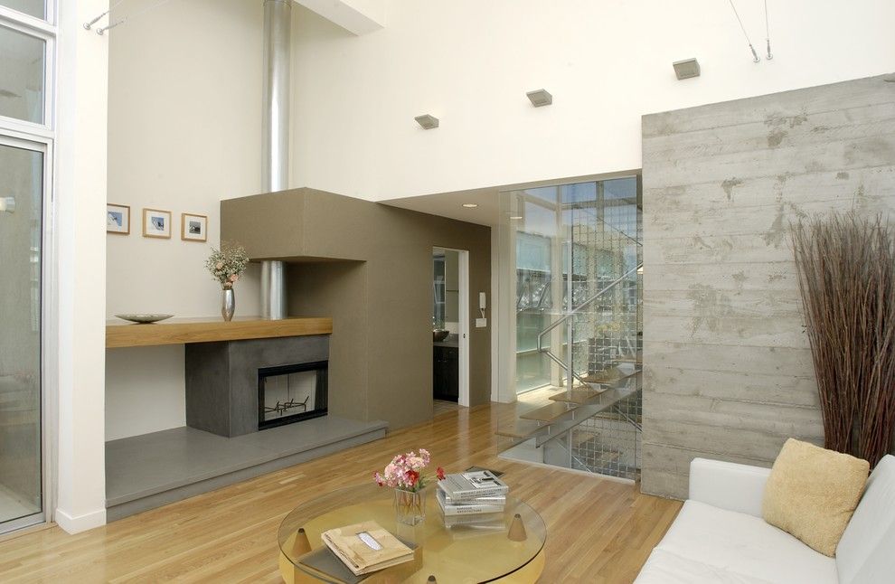Monolithic Slab for a Modern Living Room with a Concrete Walls and Living by Equinox Architecture Inc.   Jim Gelfat