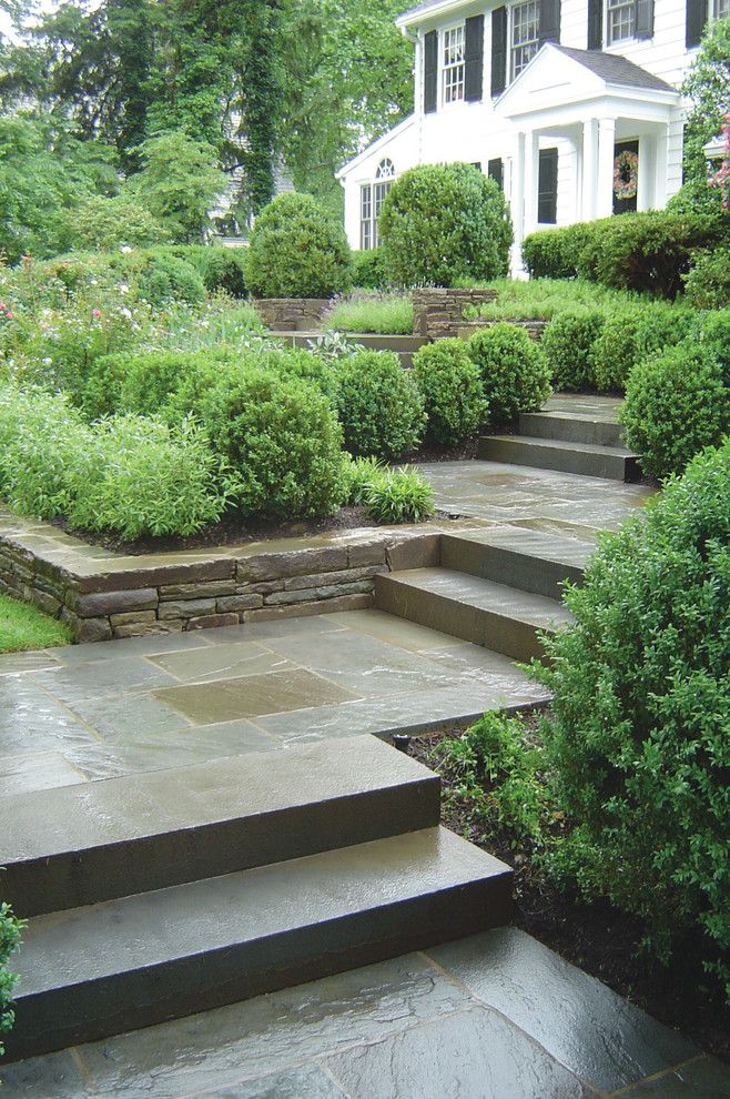 Monolithic Slab for a Traditional Landscape with a Bluestone Walkway and Bluestone Entry Walkway by the Todd Group